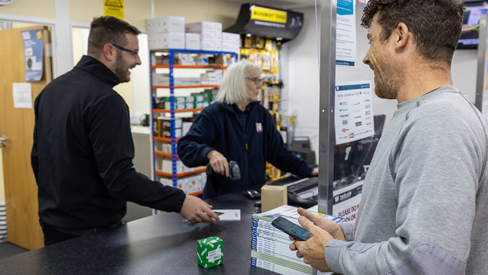 People paying for plumbing supplies at Williams plumbers' merchants